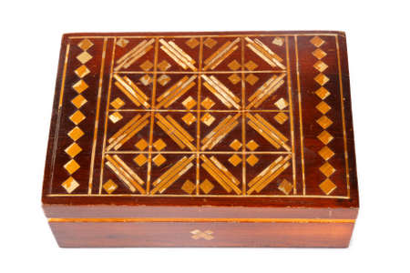 an old wooden  jewelry box with ornaments on a white backgroundの写真素材