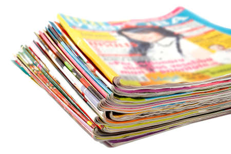 stack of old colored magazines on a white backgroundの写真素材