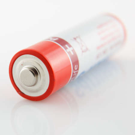 studio photography of a classic battery whit red stripes