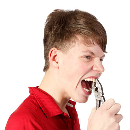 boy pulled himself  teeth with pliers against white backgroundの写真素材