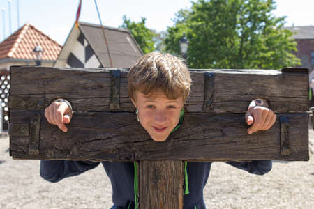 a boy trapped in a medieval torture deviceの写真素材