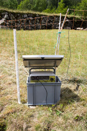 Solar energy panel with electric fence in Swiss Alpsの写真素材