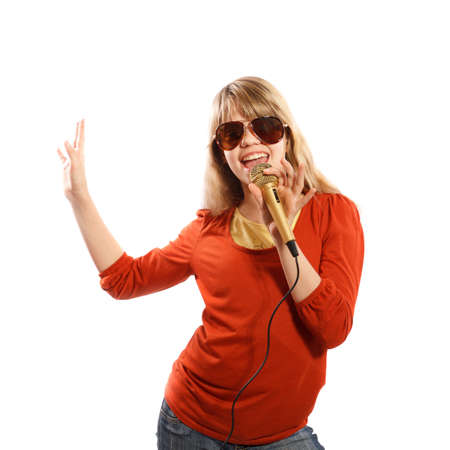 Girl singing into a microphone on a white backgroundの写真素材