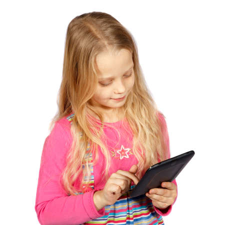 little girl using a touch screen computer on white backgroundの写真素材