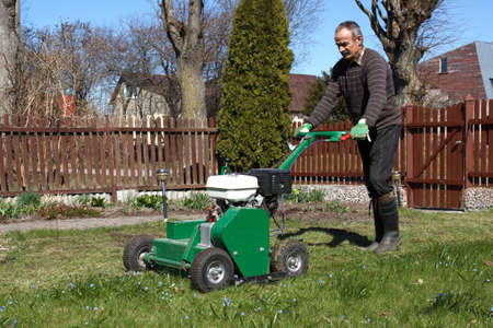 Lawn Aerator.A lawn aerator is a garden tool or machine designed to aerate the soil in which lawn grasses growの写真素材