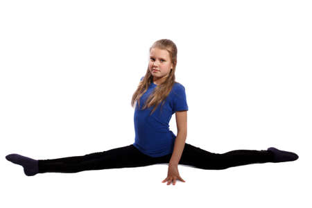 young gymnast doing splits on white backgroundの写真素材