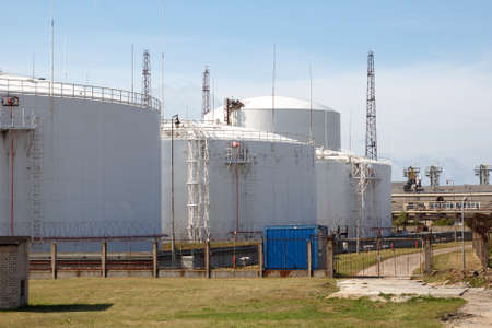 Big white industrial oil tanks to keep oilの写真素材