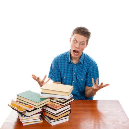 A student raging about his pile of homeworkの写真素材