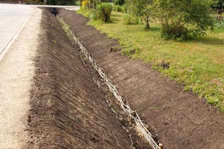 A trench by a road in a rural area