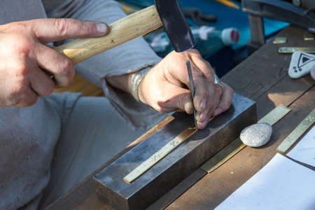 A craftsman using a hammer and a nailの写真素材