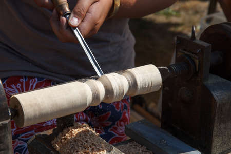 A craftsman working with wood on a latheの写真素材
