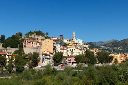 A lot of buildings built on a hill in Ventimiglia Italyの写真素材