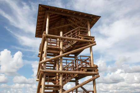 A wooden multi-storey watchtower on sky backgroundの写真素材