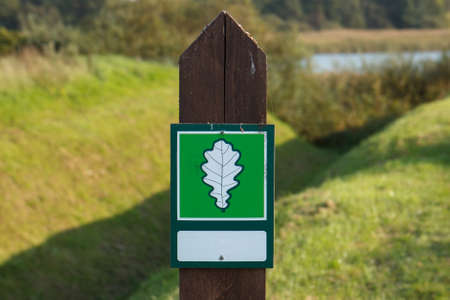 A green sign with a white leaf on itの写真素材