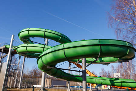An outdoors water attraction park with a green waterslideの写真素材