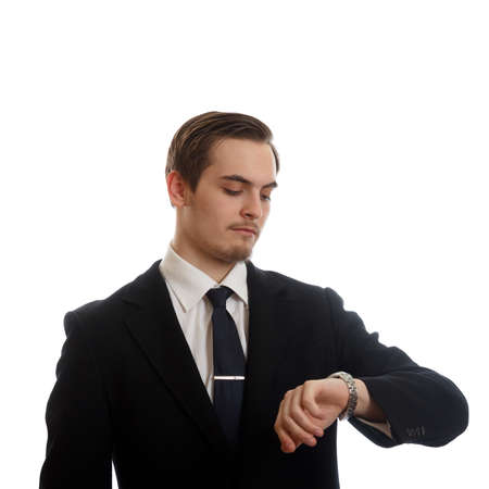A fancy young adult looking at his wristwatch