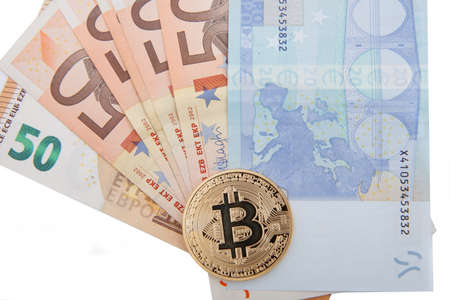 golden bitcoin souvenir coin on euro banknotes