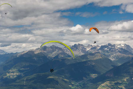 paragliding flying through the Alpsの写真素材