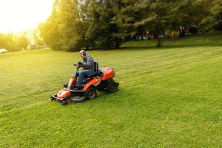 man drives a lawnmowerの写真素材