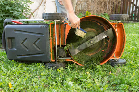 man cleaning lawn mowerの写真素材