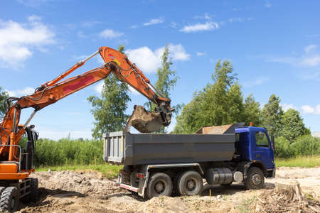 The excavator loads the tipper truck