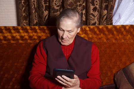 old woman read digital book