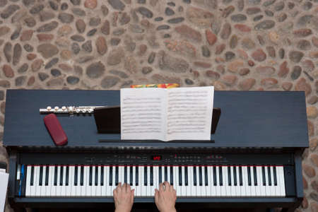 Womans hands on pianoの写真素材