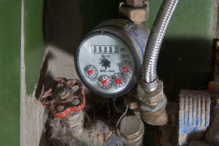 Very dirty water meter somewhere in house cellarの写真素材