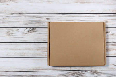 plain cardboard box on a wooden background