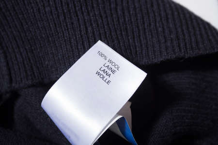 100 wool label on the sweater dark blue wool fabric.