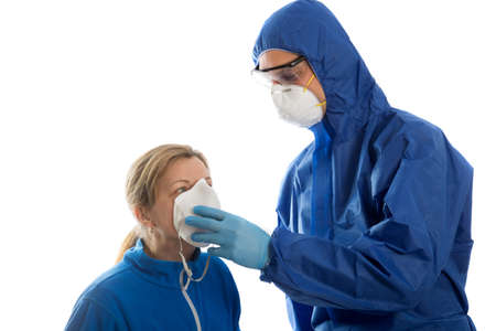 Man in protective clothing give face mask to women. Coronavirus concept.