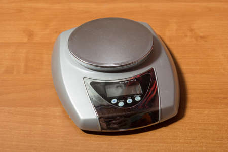 Kitchen scales on a brown wooden table