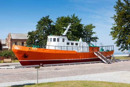 Ventspils, Latvia - August 21 2020: The pilot ship Rota, which has been working in the port of Ventspils for many years, is parked next to the so-called Winter Port.のeditorial素材