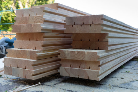 A pile of new wooden floorboards