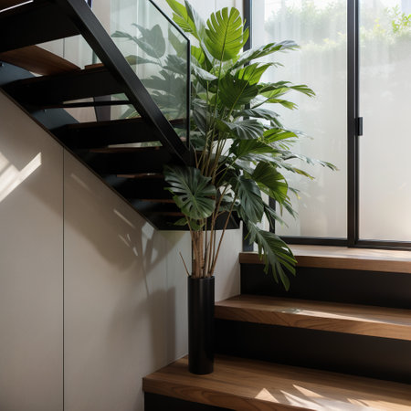 Close up wood winders of modern, elegant L shape stair with black granite base staircase, tropical tree in sunlight from window onの素材