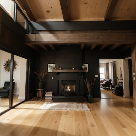 Open concept living room with fireplace wooden beams black door frames and autumn colorsの素材