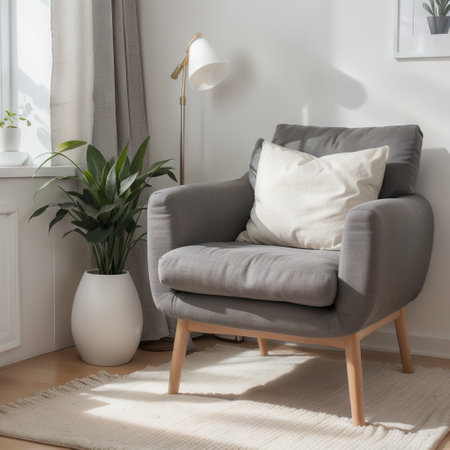 Simple and cozy scandinavian style livingroom interior with grey armchair, pillow, books, cup and twigs in vase on clear white walの素材