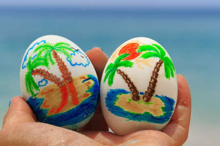 Easter eggs, painted with palms in woman's handの写真素材