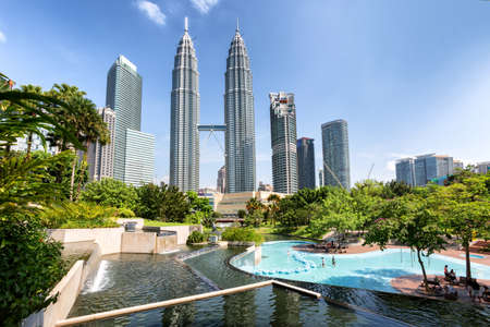 Kuala Lumpur, Malaysia - April 19, 2015: Petronas Twin towers panorama, Kuala Lumpur central park...