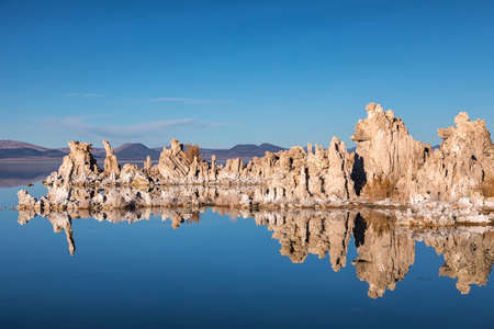 Sunset at Mono lake, California. Bizarre calcareous tufa formation on the smooth water of the lake.の写真素材