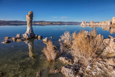 Sunset at Mono lake, California. Bizarre calcareous tufa formation on the smooth water of the lake.の写真素材