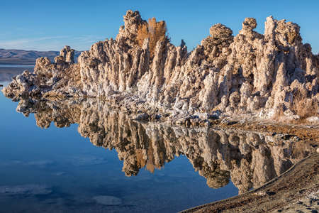 Sunset at Mono lake, California. Bizarre calcareous tufa formation on the smooth water of the lake.の写真素材