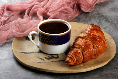 fresh croissants with a cup of coffee on the table. Traditional french breakfastの写真素材
