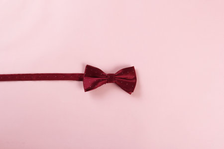 Red bow tie on pink background, selective focus, copy spaceの写真素材