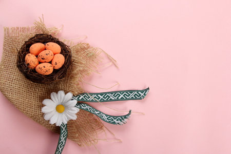 Bird nests with eggs on a colored background, Easter concept. Top view, selective focus, copy space