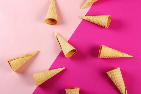 Emty Ice cream cones pattern on pink background. Top view. Several wafer ice cream cones designeの写真素材