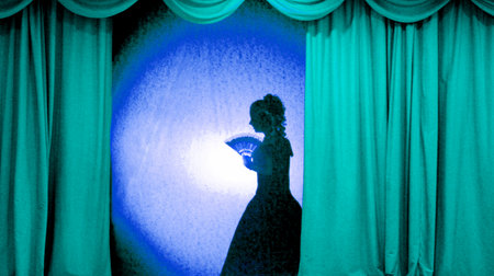 A man and woman in theatrical costumes in the theater of shadows on the stage with red curtains....