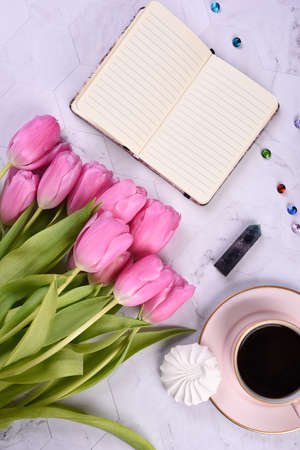 Purple tulips, coffee mug, white photo frame, laptop, gemstone crystals, copy spaceの写真素材
