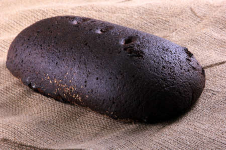 Whole rye bread loaf on the table. Traditional Latvian rye bread