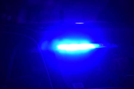 Blue flasher on the police car at night. Police car in action. Police car with blue lights at night....